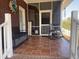 Inviting screened porch with tile flooring, rocking chair, and cozy seating offers a relaxing outdoor space at 3618 Highway 430, Nichols, SC 29581