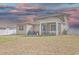 The backyard features a covered patio, grill, green grass, and a white vinyl fence at 404 Cattle Drive Circle, Myrtle Beach, SC 29588