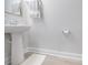 Clean bathroom with a pedestal sink, light wood floors, and neutral colored paint at 404 Cattle Drive Circle, Myrtle Beach, SC 29588