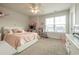 Bright bedroom featuring a ceiling fan, window, plush carpet, and charming decor at 404 Cattle Drive Circle, Myrtle Beach, SC 29588