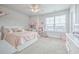 Charming bedroom with a pink bed, playful decor, and a large window at 404 Cattle Drive Circle, Myrtle Beach, SC 29588