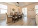 Bright dining area featuring modern lighting and decor, adjacent to the living area and kitchen at 404 Cattle Drive Circle, Myrtle Beach, SC 29588