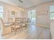 Elegant dining room with a wooden table, stylish chairs, and a sliding glass door to the backyard at 404 Cattle Drive Circle, Myrtle Beach, SC 29588