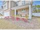 Inviting front porch with chairs, beautiful landscaping and exterior stonework detail at 404 Cattle Drive Circle, Myrtle Beach, SC 29588
