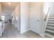 Bright hallway with neutral paint, wood-look floors, and access to stairs and other rooms at 404 Cattle Drive Circle, Myrtle Beach, SC 29588