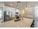 Bright kitchen with quartz countertops, a stainless steel refrigerator, and stylish pendant lights above island at 404 Cattle Drive Circle, Myrtle Beach, SC 29588