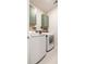 Bright laundry room featuring modern washer and dryer, shelving, and stylish green cabinets at 404 Cattle Drive Circle, Myrtle Beach, SC 29588