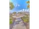 Picturesque park with American flag surrounded by palm trees, a lake, and residential community at 404 Cattle Drive Circle, Myrtle Beach, SC 29588