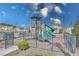 Community playground with slides, climbing structures, and safety fencing on a sunny day at 404 Cattle Drive Circle, Myrtle Beach, SC 29588