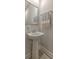 Simple powder room featuring a pedestal sink, large mirror, and neutral decor at 404 Cattle Drive Circle, Myrtle Beach, SC 29588