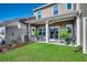 Manicured backyard featuring a covered patio with outdoor seating and a lush lawn at 4123 Mclamb Ave. # 4123, Little River, SC 29566