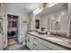 Bathroom with double vanity, granite counters, ample storage, and walk-in closet access at 4123 Mclamb Ave. # 4123, Little River, SC 29566