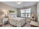 Bright bedroom with a floral-patterned bedspread, a window, and a cat tree at 4123 Mclamb Ave. # 4123, Little River, SC 29566