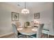 Cozy dining area with stylish chandelier, round table, and seating for four at 4123 Mclamb Ave. # 4123, Little River, SC 29566