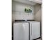 Convenient laundry room featuring a side-by-side washer and dryer with overhead shelving at 4123 Mclamb Ave. # 4123, Little River, SC 29566