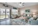 Coastal living room with a sofa, chairs, ceiling fan, area rug, and sliding glass doors at 4123 Mclamb Ave. # 4123, Little River, SC 29566