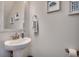 Stylish powder room with pedestal sink, coastal decor, and modern fixtures at 4123 Mclamb Ave. # 4123, Little River, SC 29566