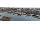 Aerial view of waterfront homes along canal featuring private docks and pools in coastal community at 414 S Dogwood Dr., Garden City Beach, SC 29576