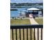 Waterfront backyard featuring a dock with boat and a covered seating area on the waterway at 414 S Dogwood Dr., Garden City Beach, SC 29576