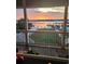 View from the porch of a waterfront backyard featuring a dock, seating and waterway at sunset at 414 S Dogwood Dr., Garden City Beach, SC 29576