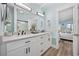 Bathroom featuring a double vanity, modern lighting, and a view to the adjacent bedroom at 414 S Dogwood Dr., Garden City Beach, SC 29576