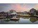 Waterfront homes featuring private docks, gazebos and swimming pools in a coastal community at sunset at 414 S Dogwood Dr., Garden City Beach, SC 29576
