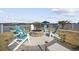 A backyard fire pit with Adirondack chairs offers a cozy outdoor gathering space overlooking the waterway at 414 S Dogwood Dr., Garden City Beach, SC 29576