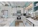 Bright and airy kitchen features white cabinetry, marble countertops, and coastal-themed decor at 414 S Dogwood Dr., Garden City Beach, SC 29576