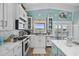 Modern kitchen boasts white cabinets, stainless steel appliances, and a view of the water at 414 S Dogwood Dr., Garden City Beach, SC 29576