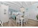 Open concept living space with adjacent dining area and kitchen boasts bright natural light at 414 S Dogwood Dr., Garden City Beach, SC 29576