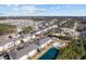 Aerial view of a condo community with a pool, pond, parking and lush landscaping at 4142 Hibiscus Dr. # 104, Little River, SC 29566