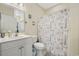 Bathroom with a vanity, toilet, and shower featuring a patterned curtain at 4142 Hibiscus Dr. # 104, Little River, SC 29566