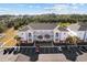 Condominium building boasts three stories, light pink siding, white balconies, palm trees, and ample parking at 4142 Hibiscus Dr. # 104, Little River, SC 29566