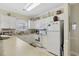 Well-lit kitchen with white appliances, offering a clean and functional cooking space at 4142 Hibiscus Dr. # 104, Little River, SC 29566