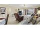 Inviting living room with tile floors, ceiling fan, and sliding glass doors to the exterior at 4142 Hibiscus Dr. # 104, Little River, SC 29566