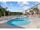 Community pool and deck with lounge chairs, with a lake in the background at 4142 Hibiscus Dr. # 104, Little River, SC 29566