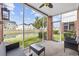 Relaxing screened-in porch with outdoor seating, overlooking a tranquil backyard pond and green space at 4142 Hibiscus Dr. # 104, Little River, SC 29566