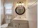 Cozy bathroom featuring a round mirror, updated vanity, and good lighting at 4243 Rivergate Ln., Little River, SC 29566
