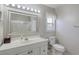 Well-lit bathroom with a large mirror, vanity, and shower with glass doors at 4243 Rivergate Ln., Little River, SC 29566