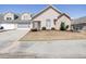 Attractive home featuring stone accents, a well-manicured lawn, neutral siding, and an attached garage at 4243 Rivergate Ln., Little River, SC 29566