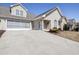 Charming home featuring a two-car garage, stone accents, well-manicured landscaping, and neutral siding at 4243 Rivergate Ln., Little River, SC 29566