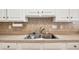 Close-up of the double basin stainless steel sink and countertops at 4243 Rivergate Ln., Little River, SC 29566
