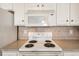 Close-up of the electric stovetop and microwave in this bright, well-maintained kitchen at 4243 Rivergate Ln., Little River, SC 29566