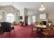 Spacious living room featuring a chandelier, a decorative fireplace, and large arched windows at 4243 Rivergate Ln., Little River, SC 29566