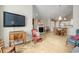 Open-concept living area features a fireplace, dining area, chandelier, and comfortable seating at 4243 Rivergate Ln., Little River, SC 29566
