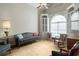 Inviting living room features built-in shelving, a large window, a ceiling fan, and comfortable seating at 4243 Rivergate Ln., Little River, SC 29566