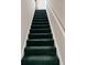 Carpeted stairway with green runner and white trim at 4243 Rivergate Ln., Little River, SC 29566