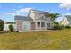 Home exterior featuring sliding glass door, sunroom, and expansive grassy backyard at 4387 Heartwood Ln., Myrtle Beach, SC 29579