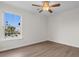 Bedroom with wood-look flooring, ceiling fan, and a bright window view at 4387 Heartwood Ln., Myrtle Beach, SC 29579