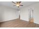 Bedroom with wood-look flooring, ceiling fan, and access to ensuite bathroom at 4387 Heartwood Ln., Myrtle Beach, SC 29579